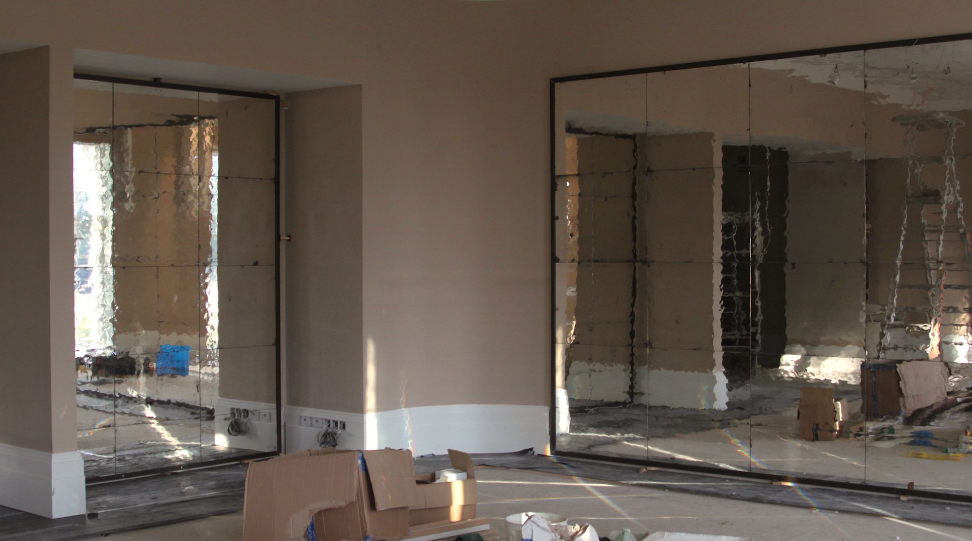 Installation of Georgian Drawn mirror at Coworth Park. Fox Linton Interiors.
